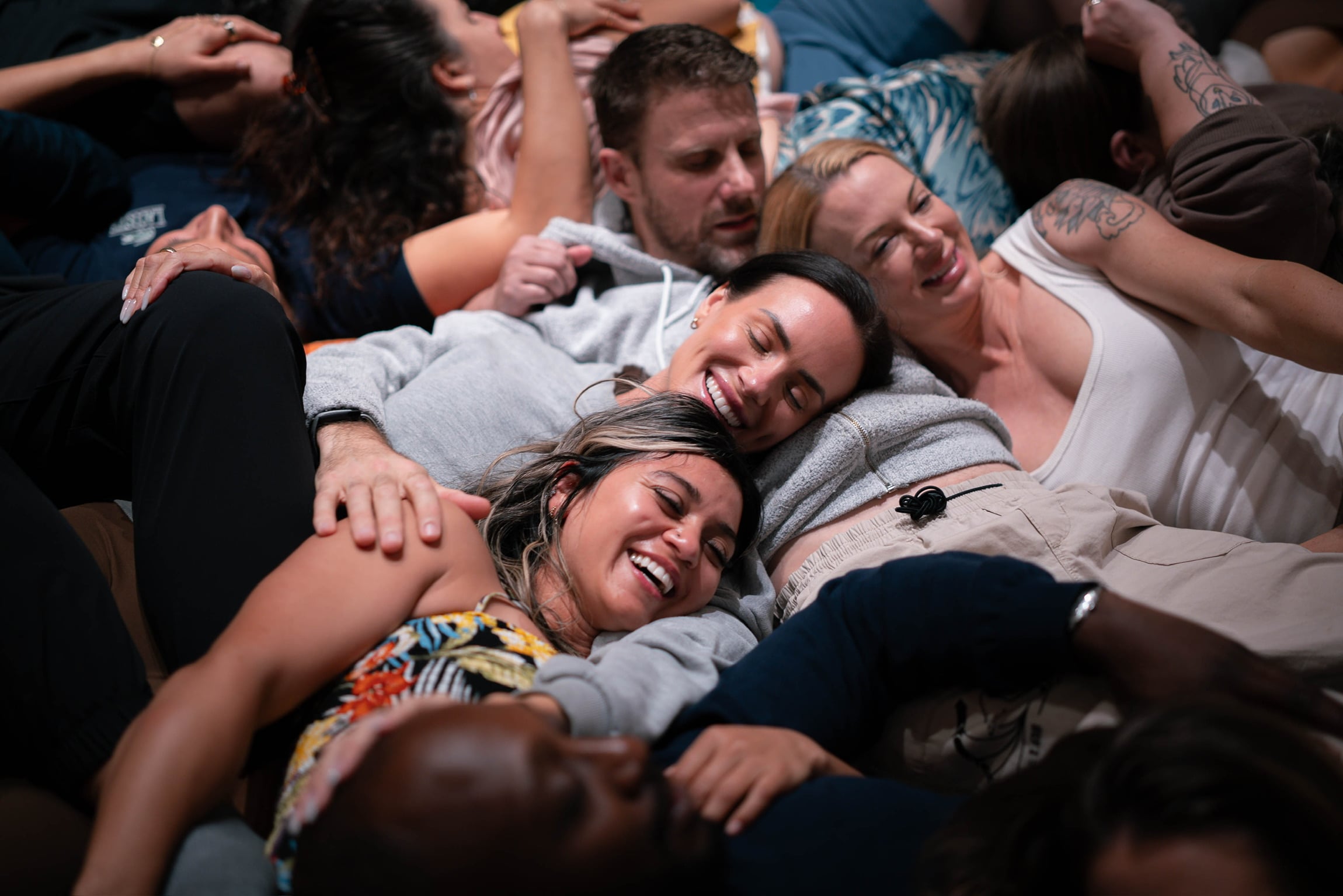 Guests lying together in a heap, laughing